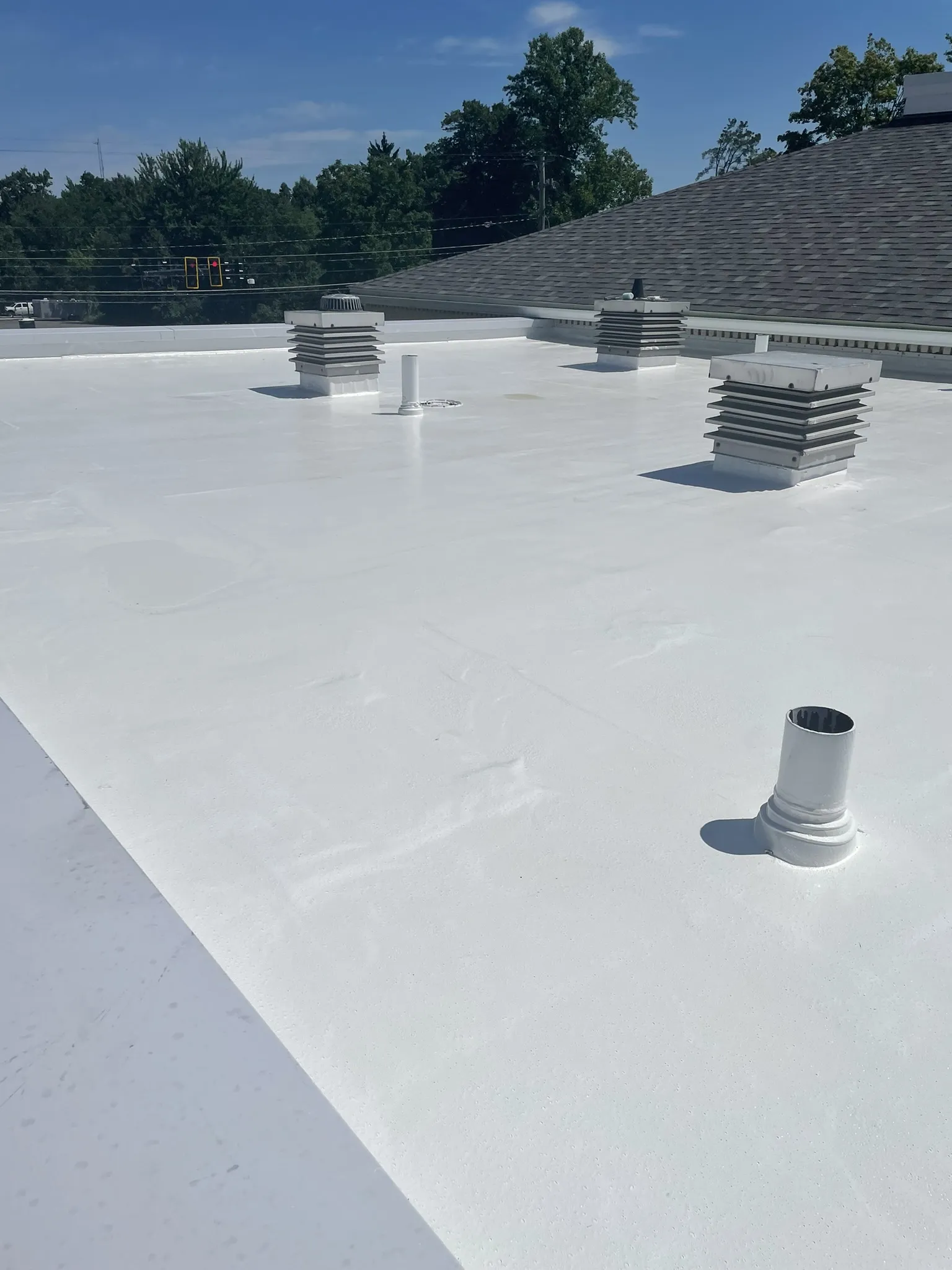 Low-sloped roofing installation with TPO membrane for energy efficiency and superior weather resistance.