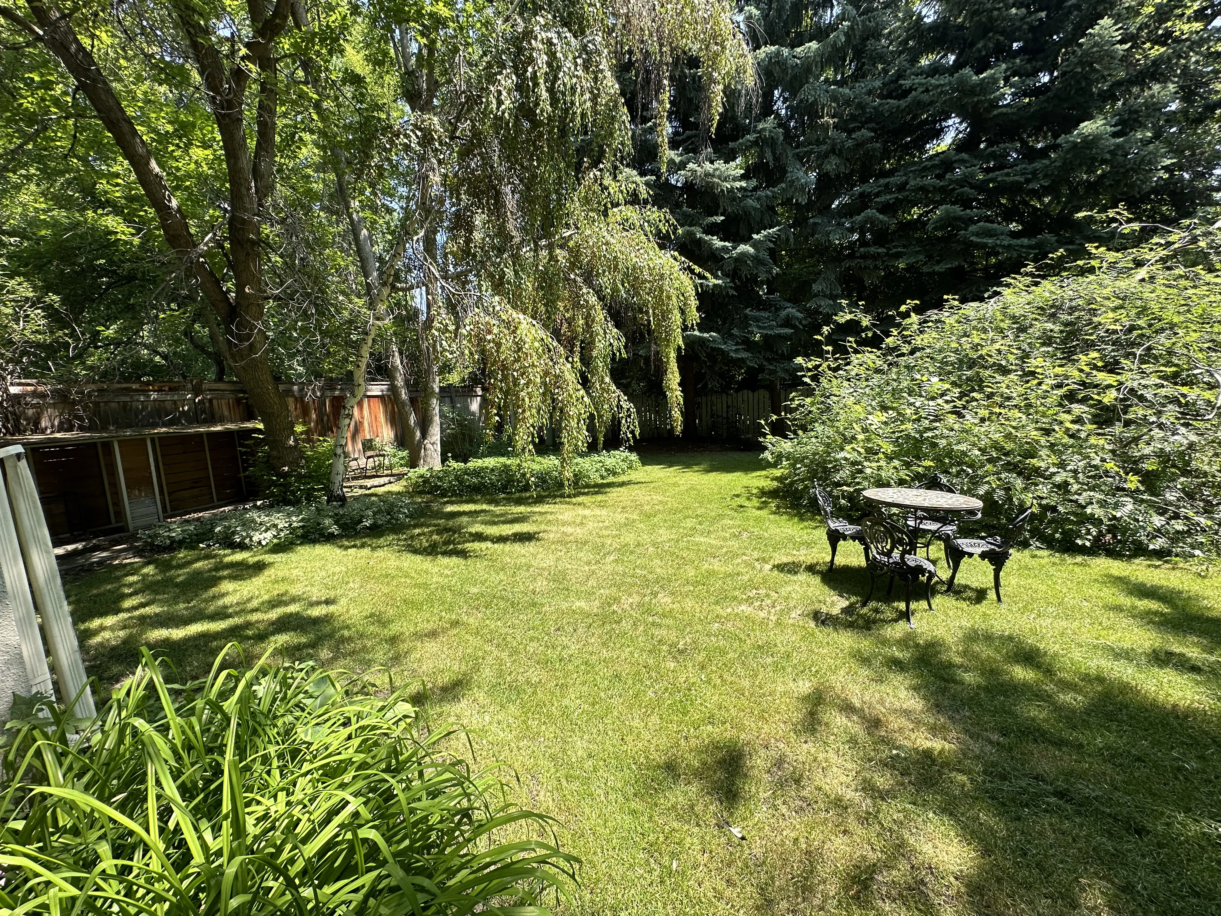 A beautiful outdoor living space and garden landscape after residential landscaping services are in Calgary, AB.