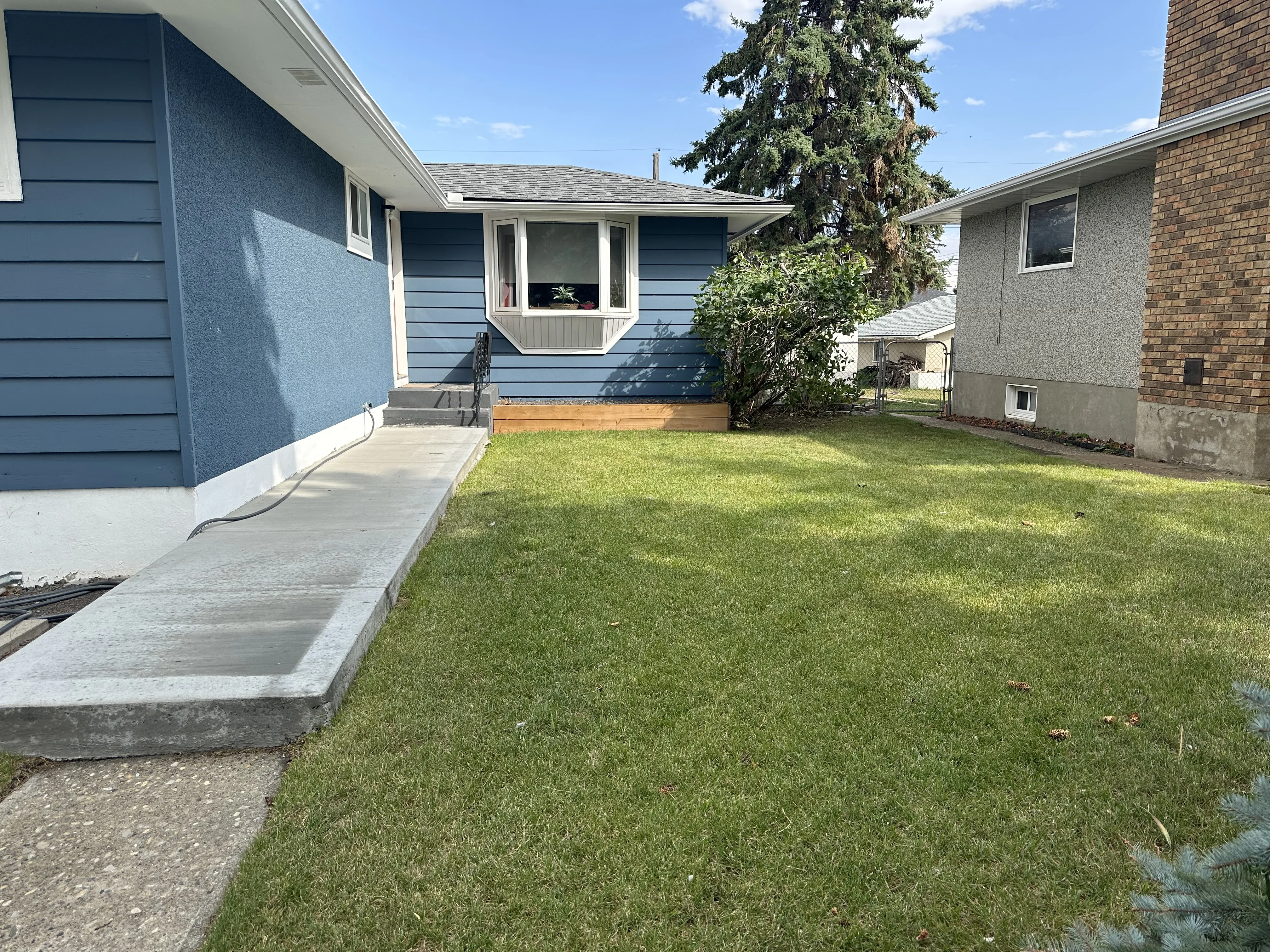 Stunning outdoor living spaces with curb appeal by landscaping companies in Calgary, AB.