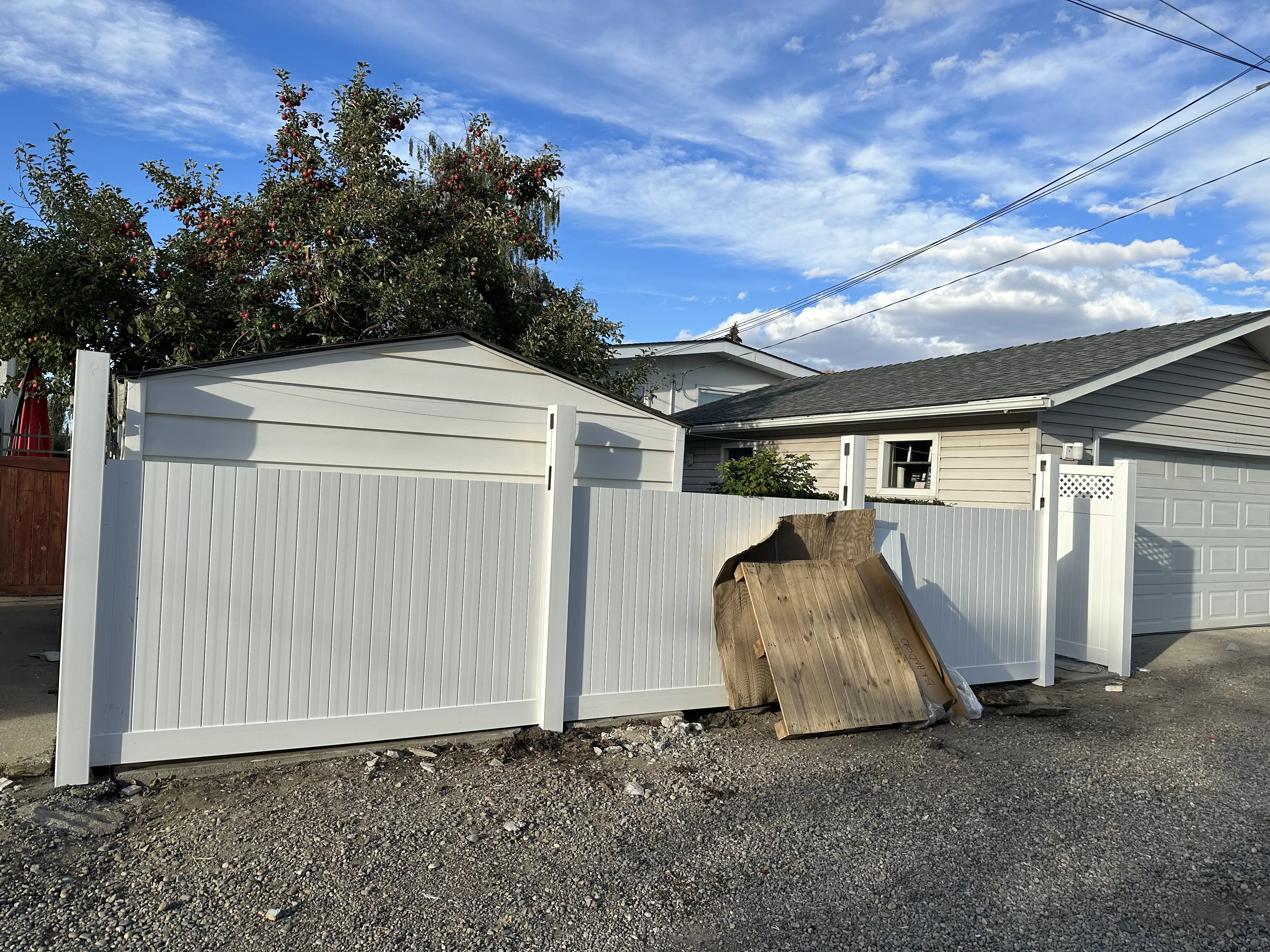 experienced professionals installing vinyl custom design, low maintenance, unique style fence in Calgary