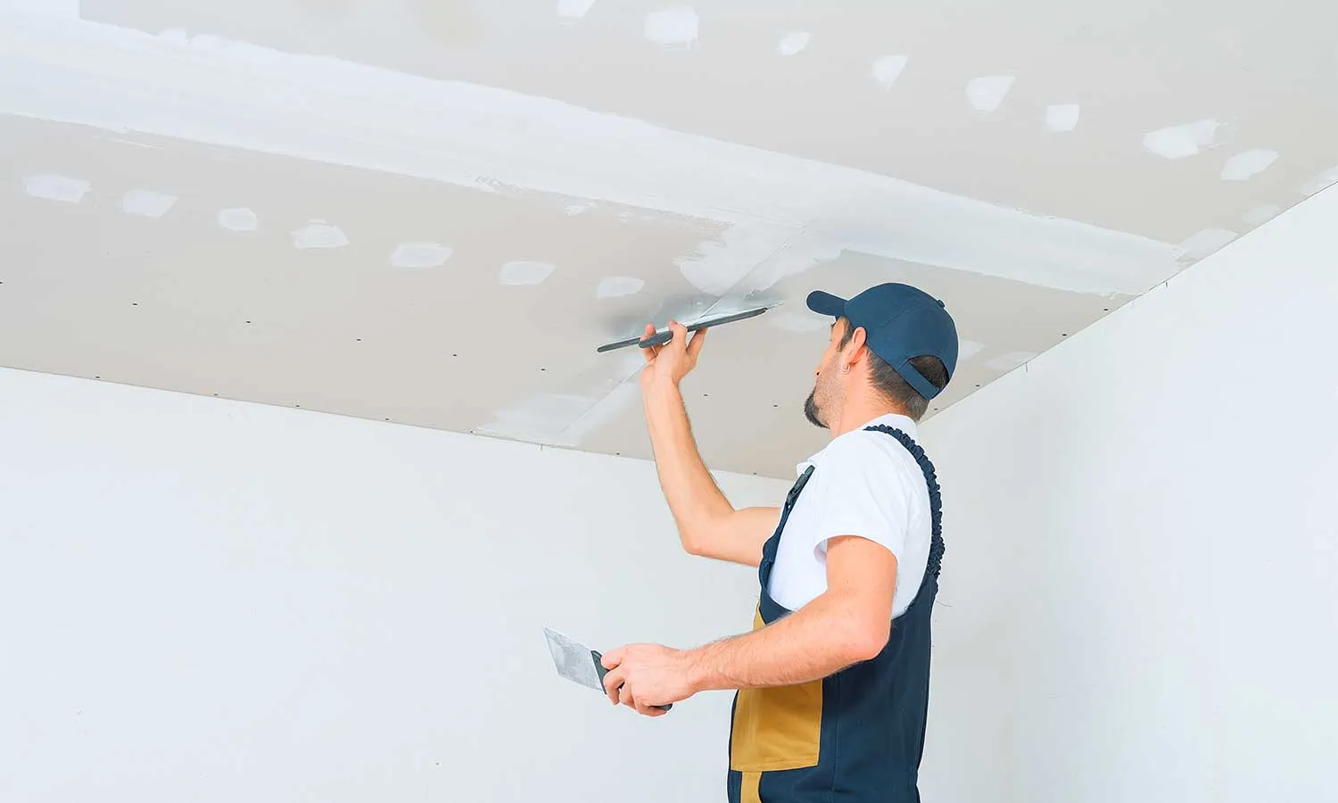 Professional performing drywall repairs in Columbus