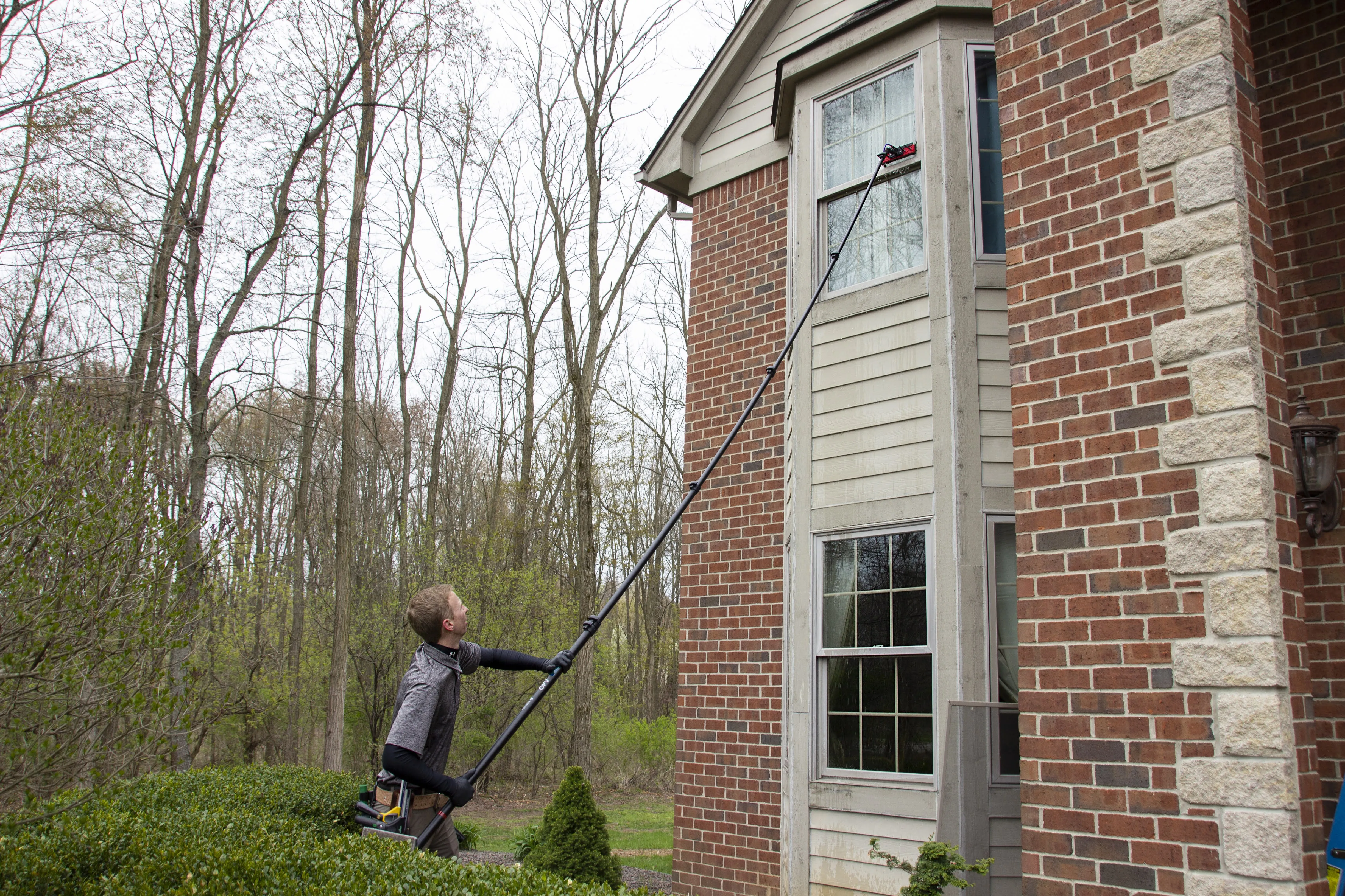A professional window cleaner doing a very good job, ensuring complete customer satisfaction in Knoxville, TN.
