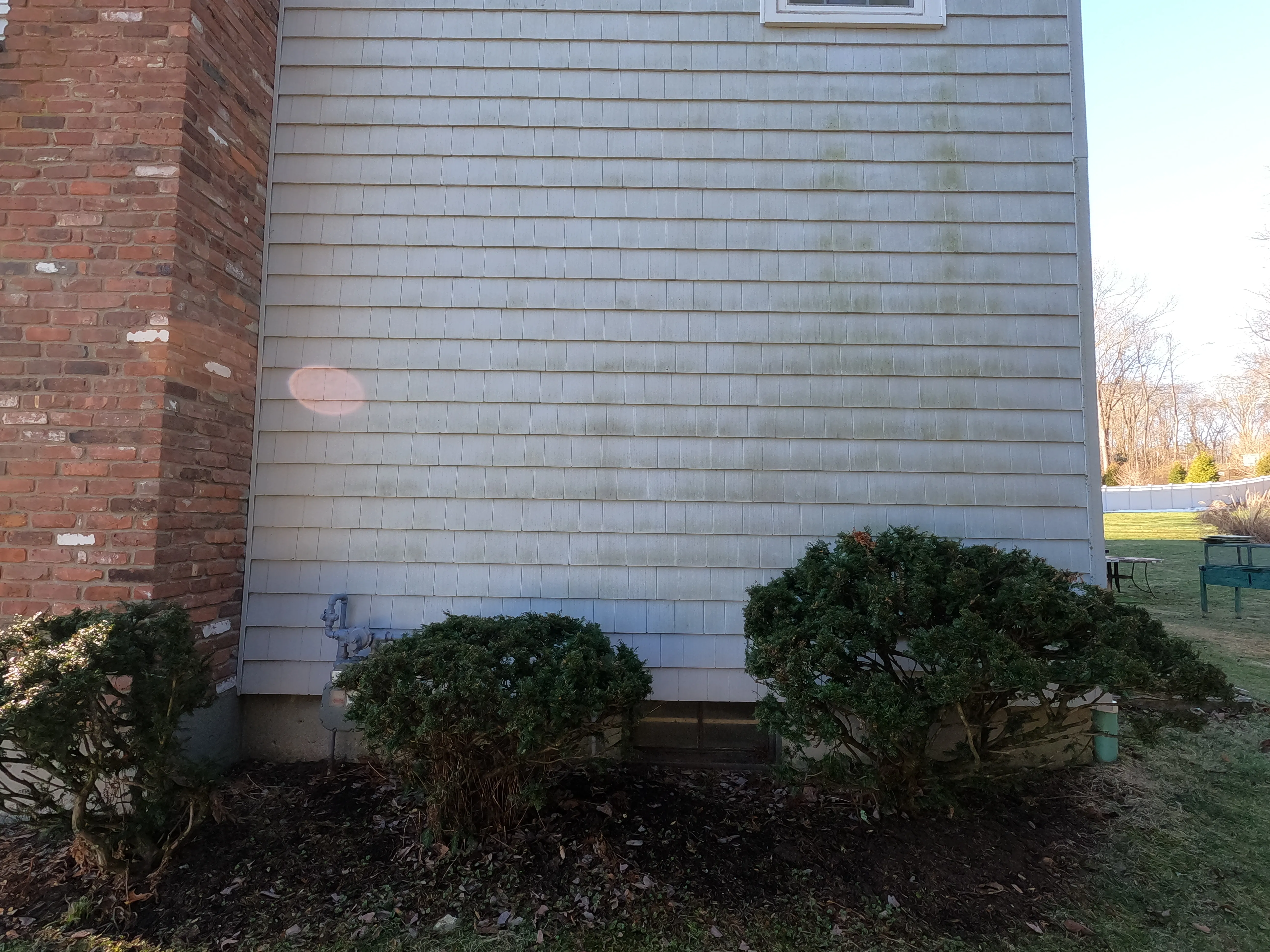 A home’s exterior in Bridgeport, CT covered in dirt and grime before softwashing.