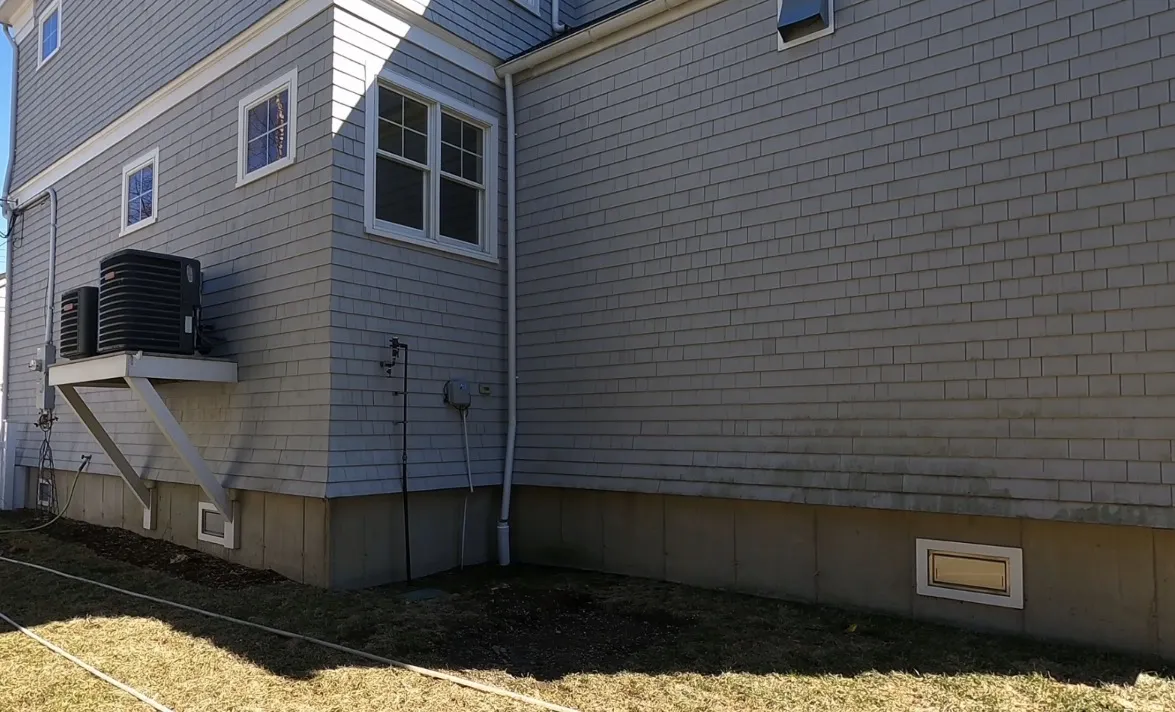 A team softwashing a home exterior in Bridgeport, CT with eco-friendly solutions.