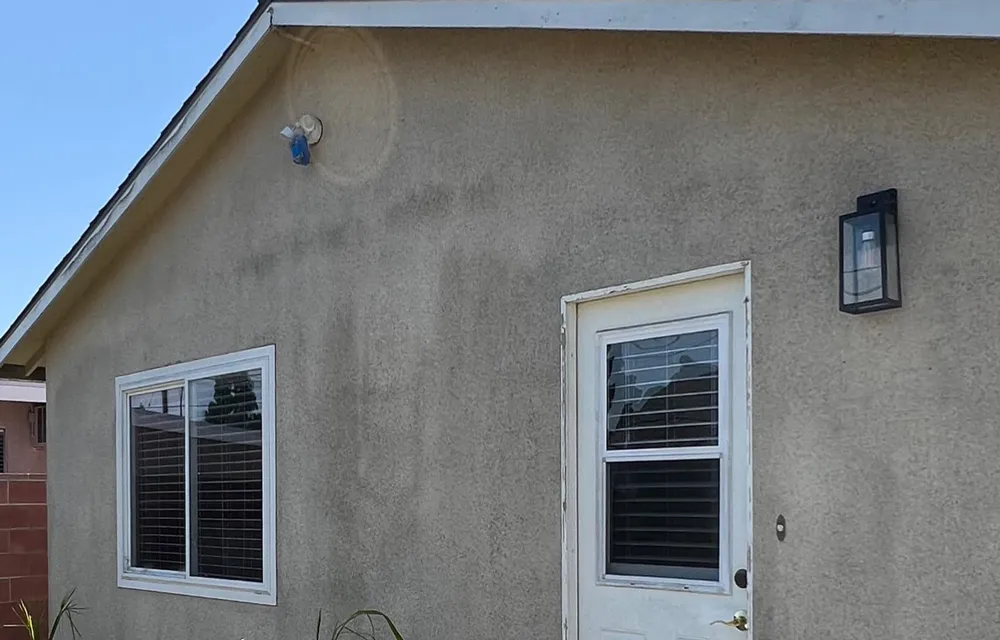 Dirty home exterior in Fullerton before Miggy's pressure washing service.