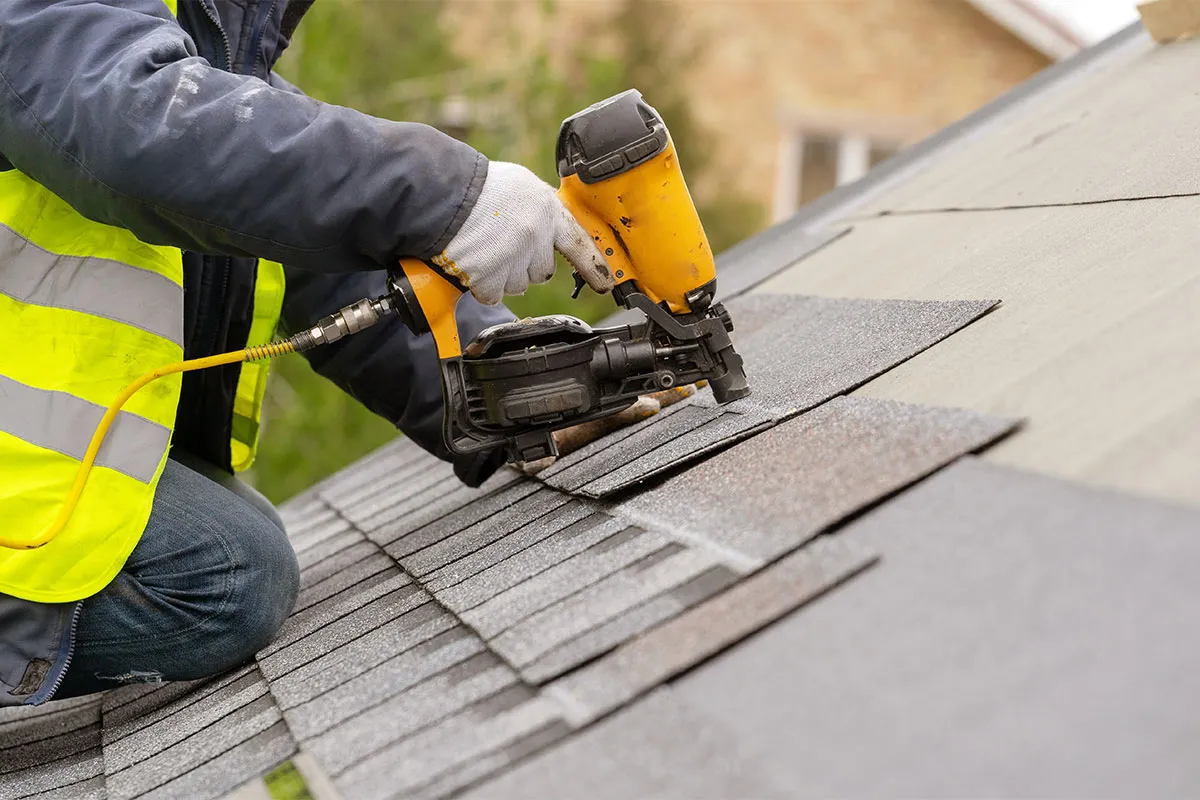 Professional performing roofing services in New Hampshire.