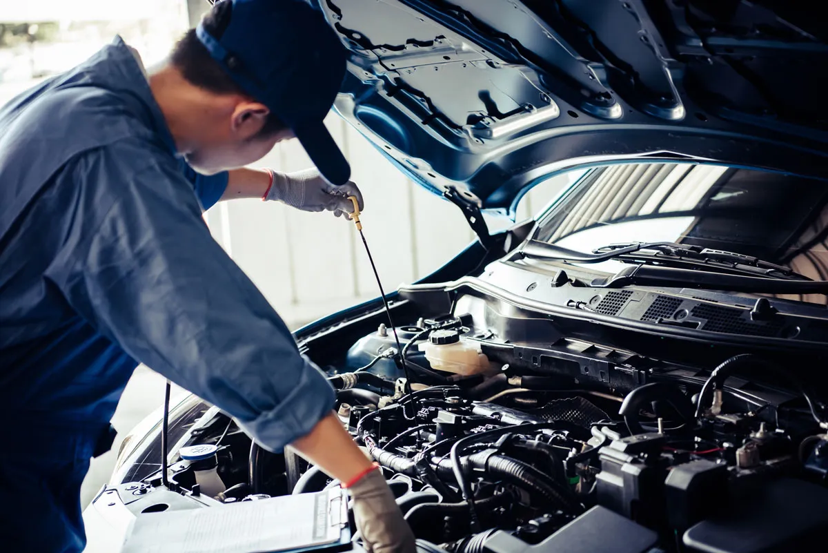 A mechanic is preparing the car for an oil change. Oil changes is one of the primary services provided for customers by AutoFix Center in Lancaster, CA.