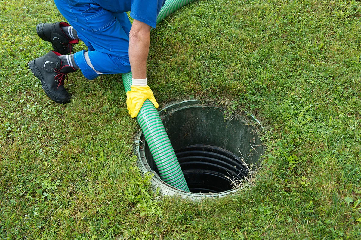 A plumbing professional cleaning a septic system.