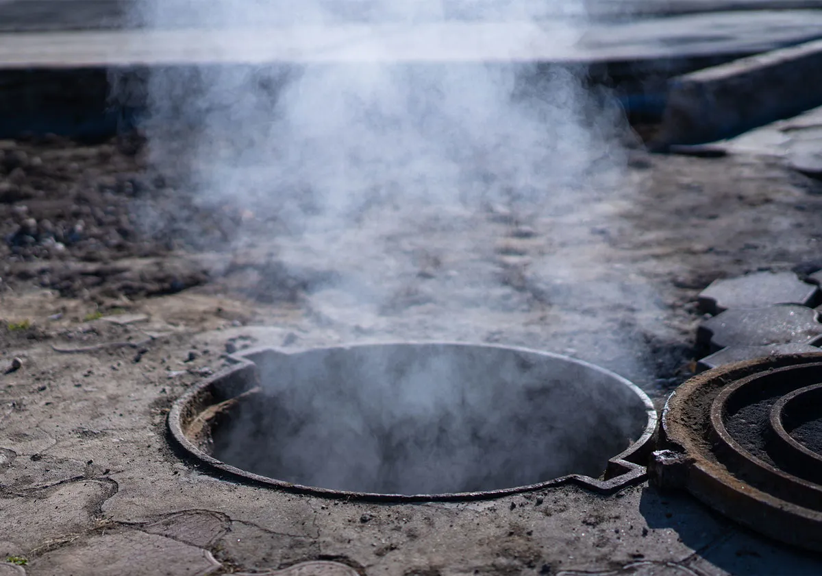 Smoke coming from a sewer.