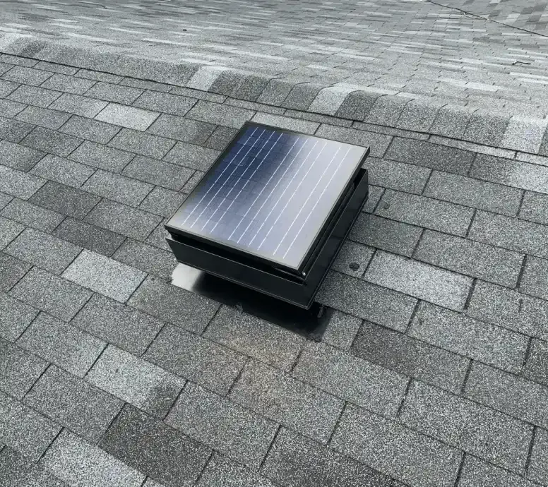 Energy-efficient solar attic fan ventilating roof space.