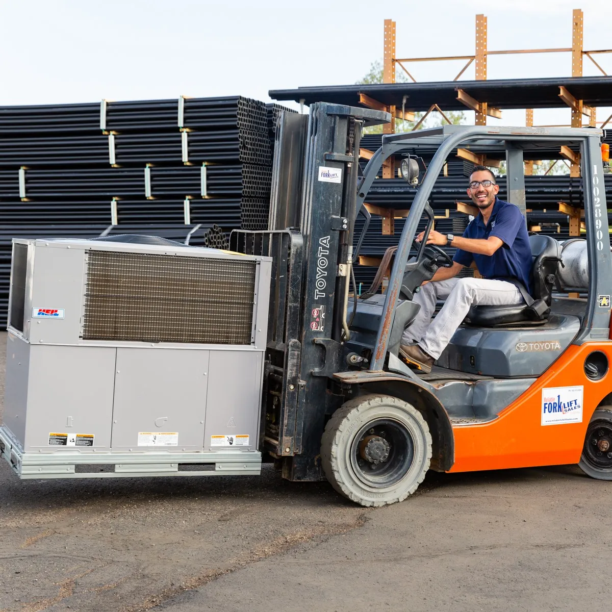 HVAC technician using a fork lift to transit a HVAC unit in Tucson.