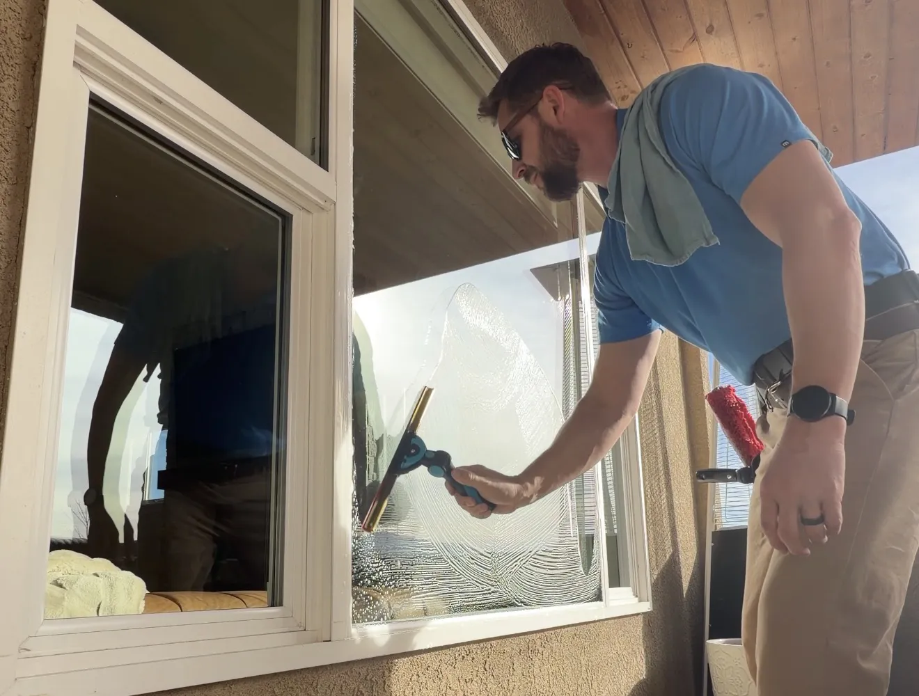 Advanced Window Cleaning & Carpet Care cleaning technician is performing water-fed pole window cleaning in Colorado Springs.