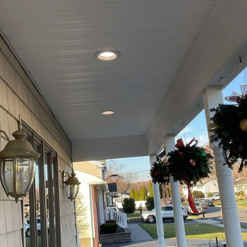 Above All Electric Heating And Cooling team installing hi-hats lighting in a Patchogue, NY home