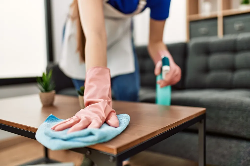 The maid is cleaning the table