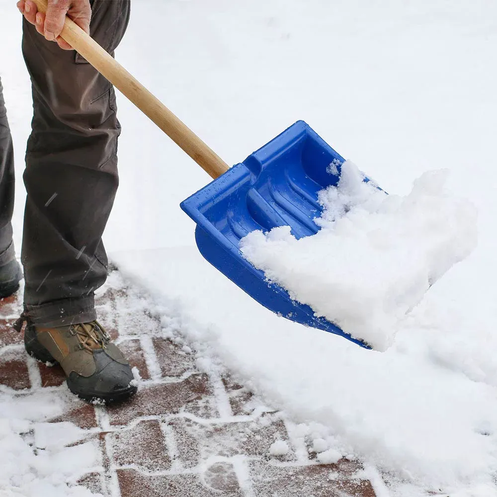 Man shoveling snow in a home walkway in Arlington, VA.