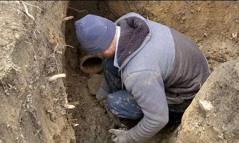 American Servicers plumbing technician performing a pipe repair.