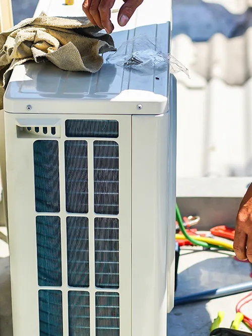 Trademark Home Services technician expertly servicing an HVAC system in Sugar Land, TX.