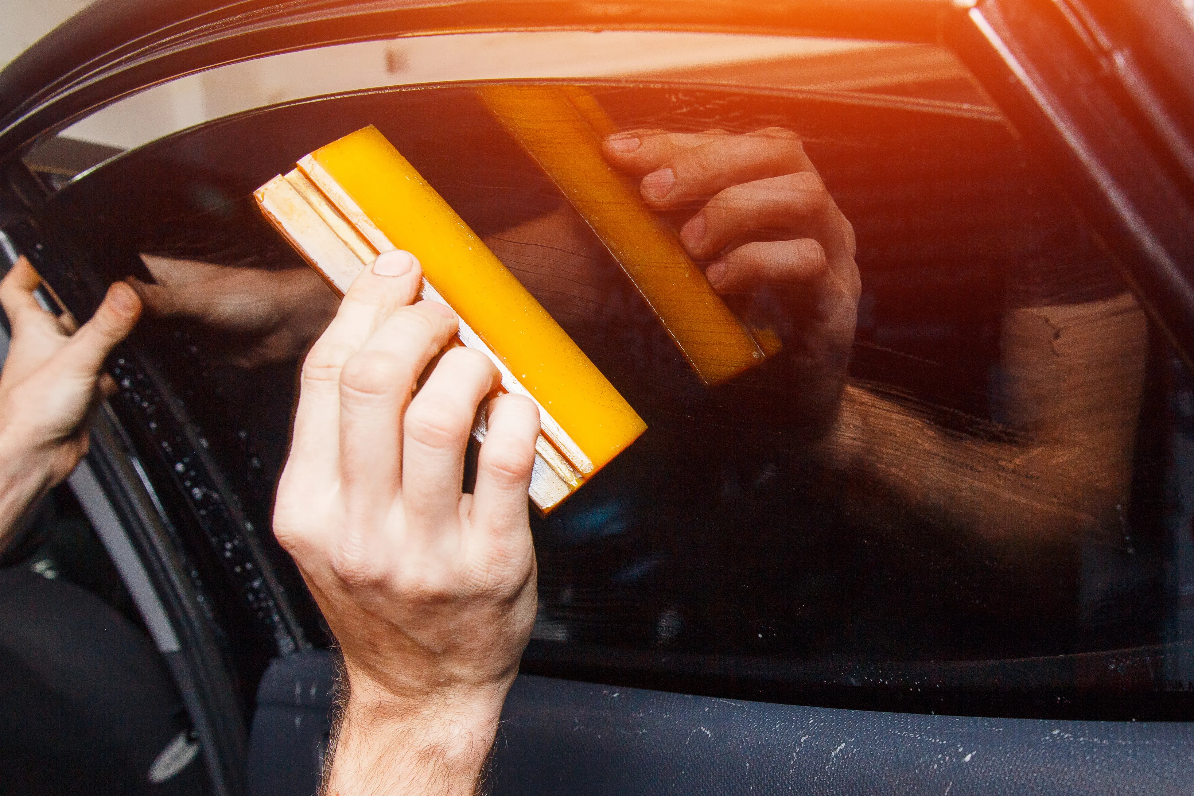 Image of a Legacy Tint professional applying window tint in Fresno, California