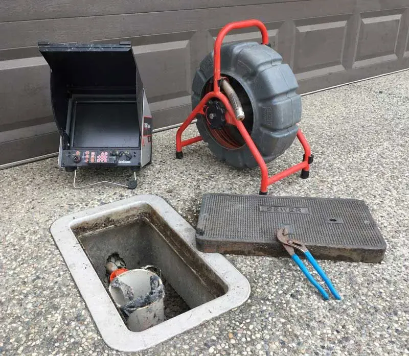 Technician using sewer camera inspection in Gainesville to diagnose buildup and perform sewer system maintenance for long-term plumbing performance.