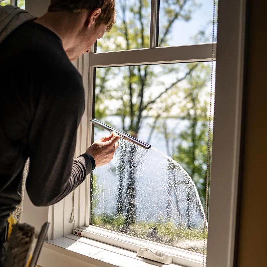 Window cleaners hand-washing with dish soap, a razor blade, and a clean cloth with a dab of mineral spirits to remove grease.