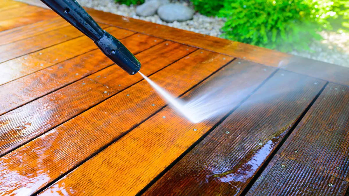 Professional deck washing is in progress.