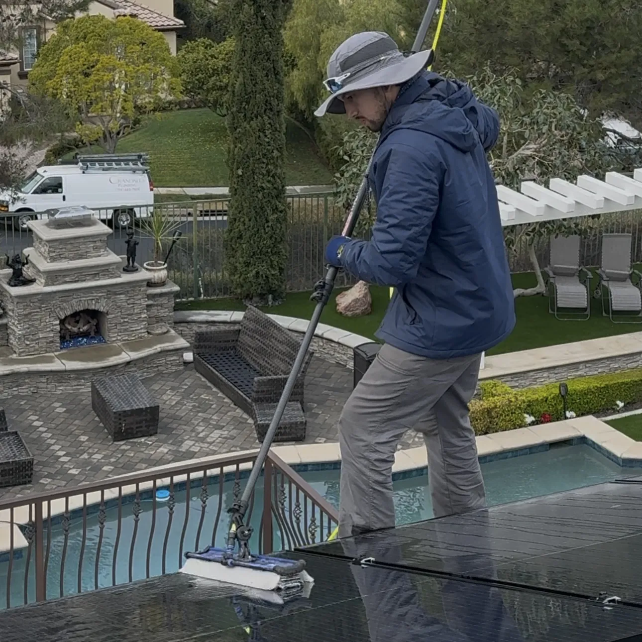 A BrightWorks Cleaning technician is providing effective cleaning for the solar panels of a residential home in Irvine.