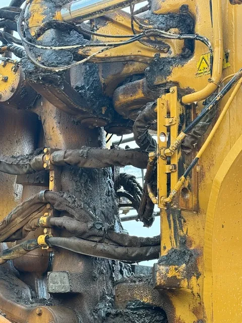 Construction equipment covered in grime before cleaning solution, water pressure, and thorough job.