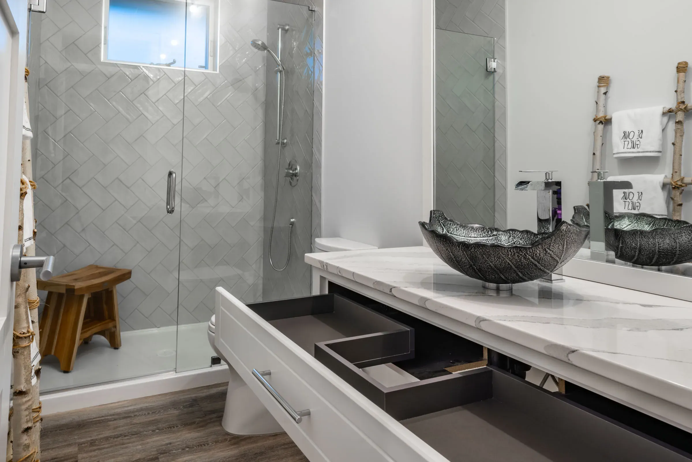 A clean bathroom in the Comox Valley with an open drawer that is clean inside.