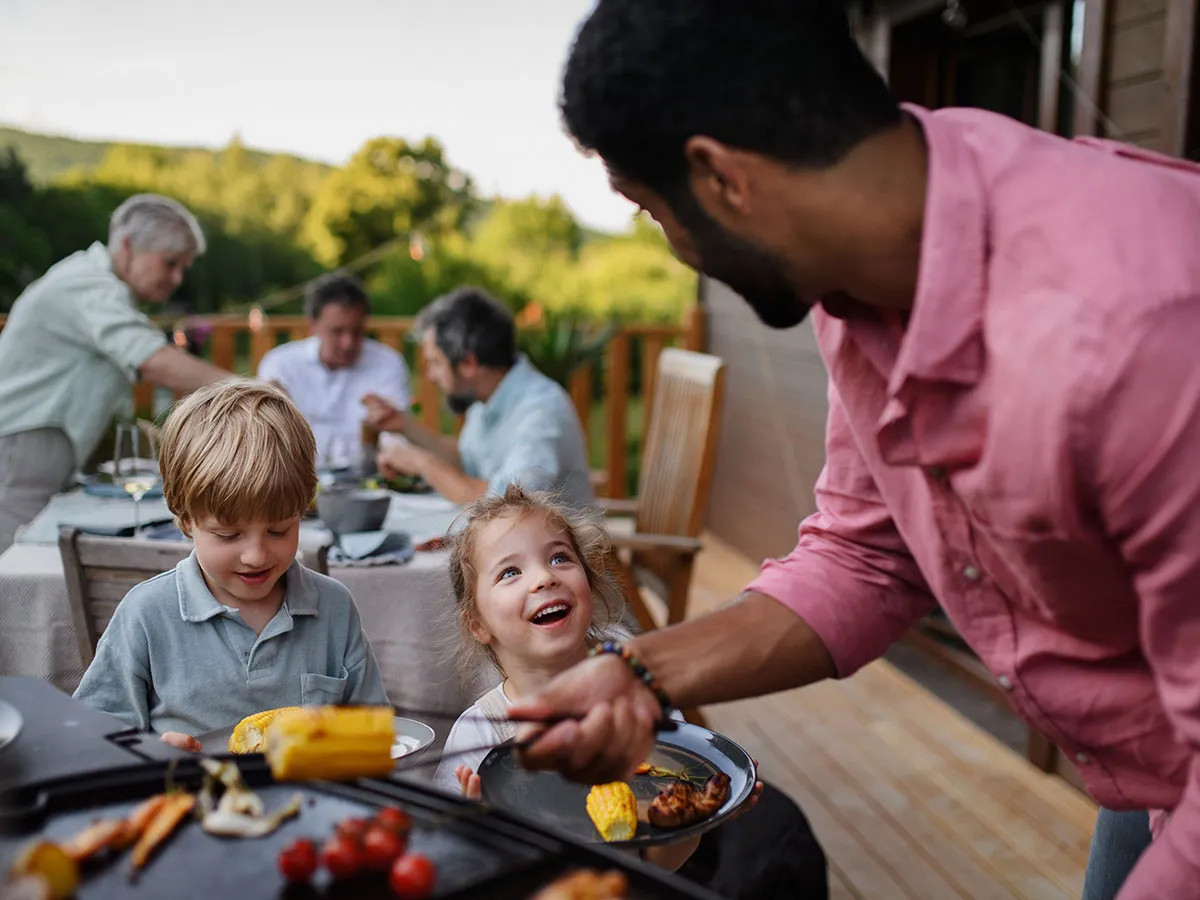 A family enjoying a BBQ in the garden.