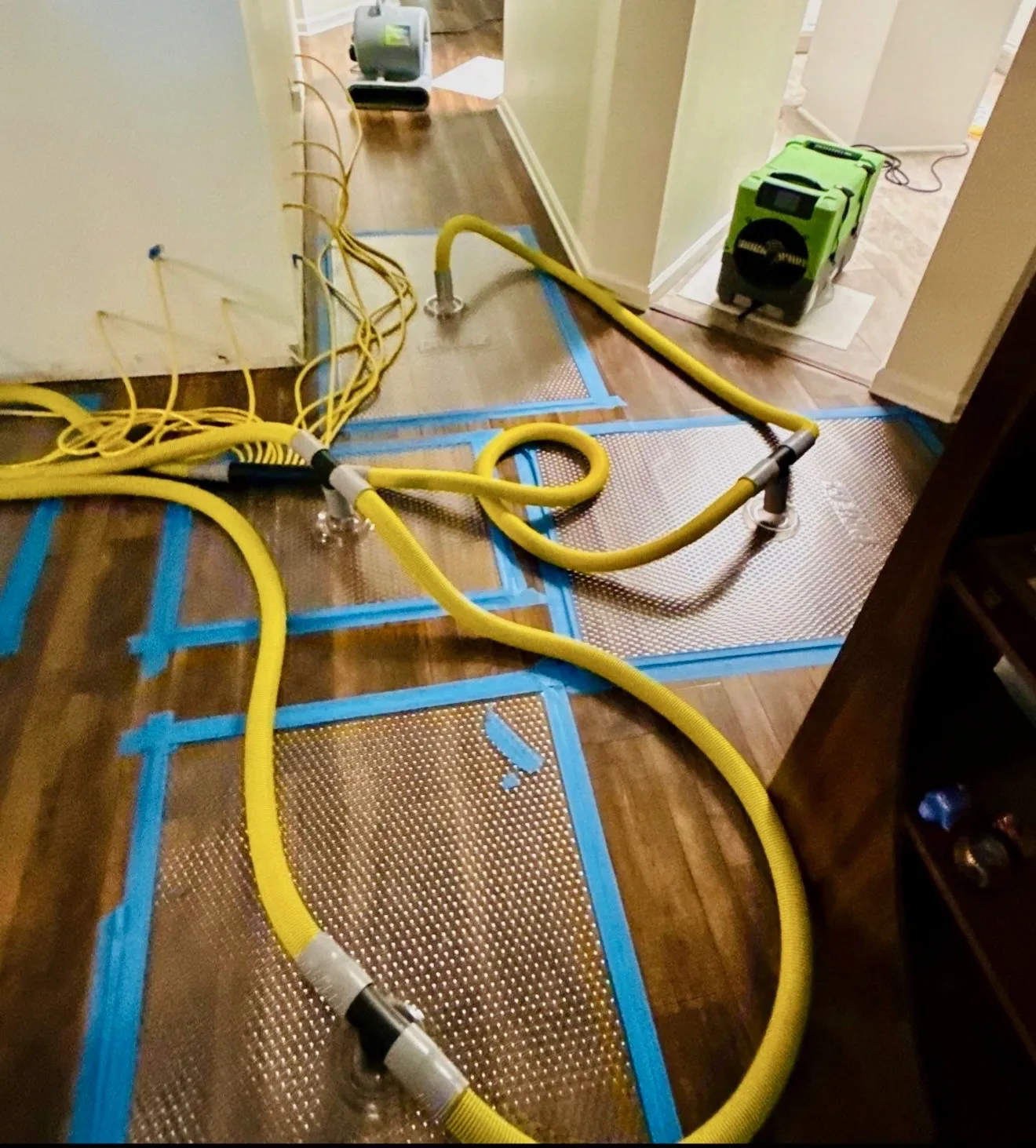Local team repairing water-damaged hardwood in a North Richland home.