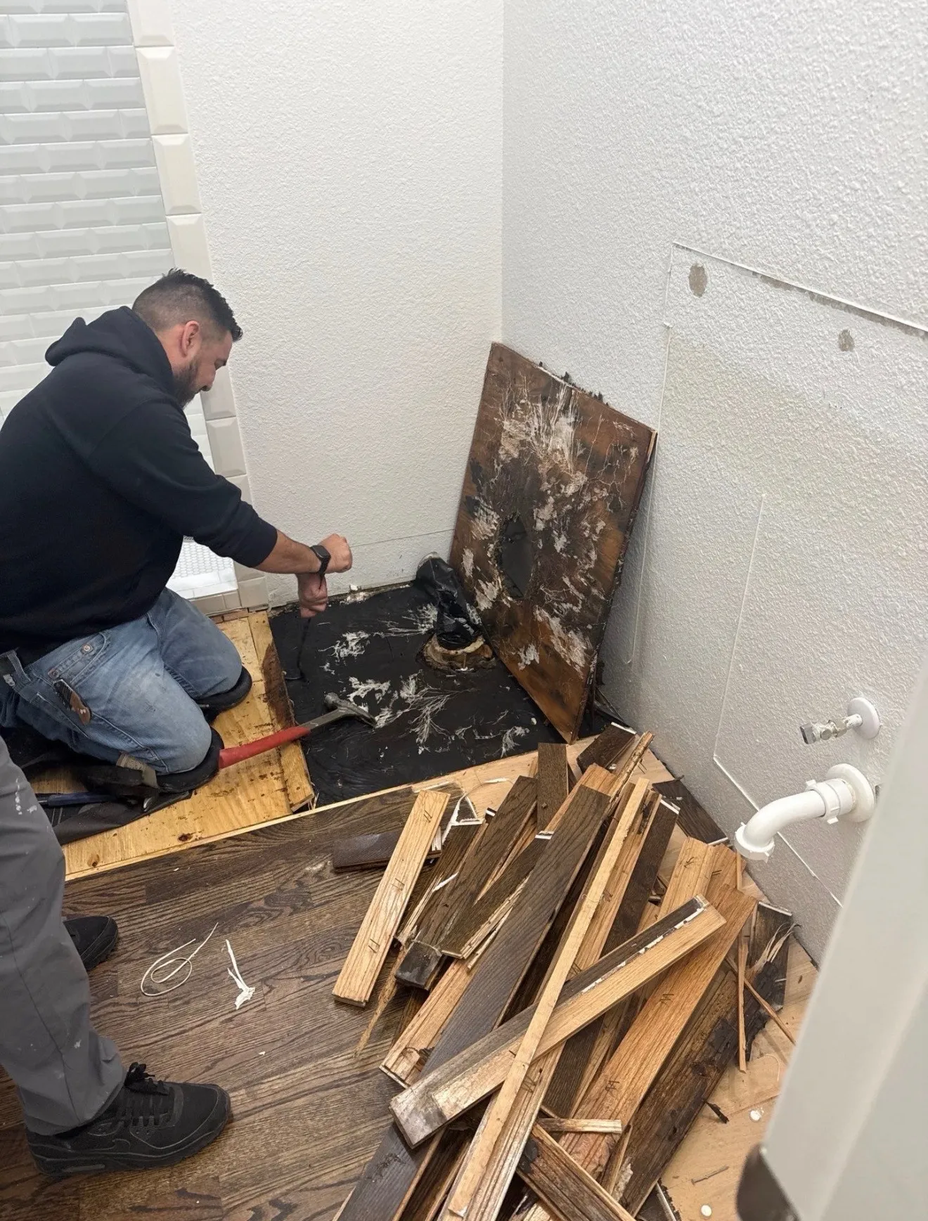 The skilled hands of a Midcity Steam technician meticulously restoring water-damaged hardwood floors in North Richland Hills.