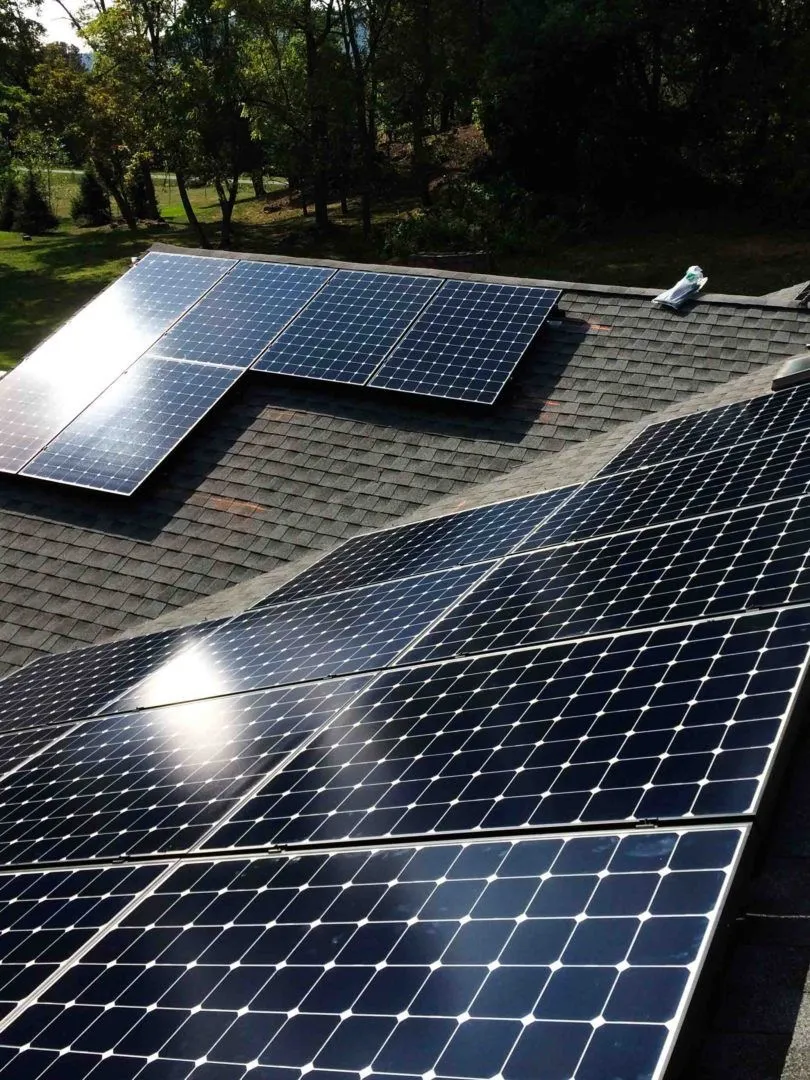 A professional cleaning a window with a squeegee in Biddeford, ME
