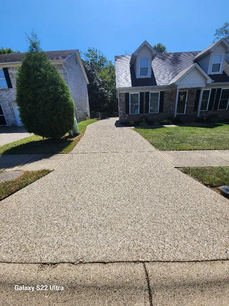 Concrete cleaning for a driveway with professional pressure washing services, showing a clean and well-maintained exterior surface.