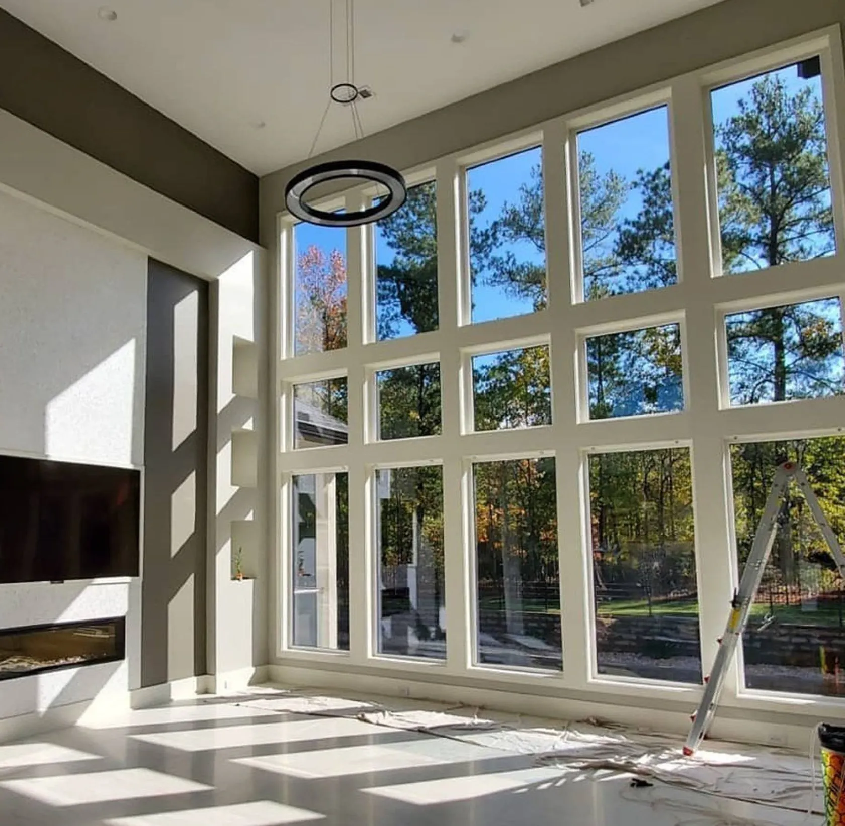 Modern living room with professional installation of window tint to reduce energy costs, and stay cool while offering legal tint and exceptional customer service for automotive vinyl wraps at the best price.