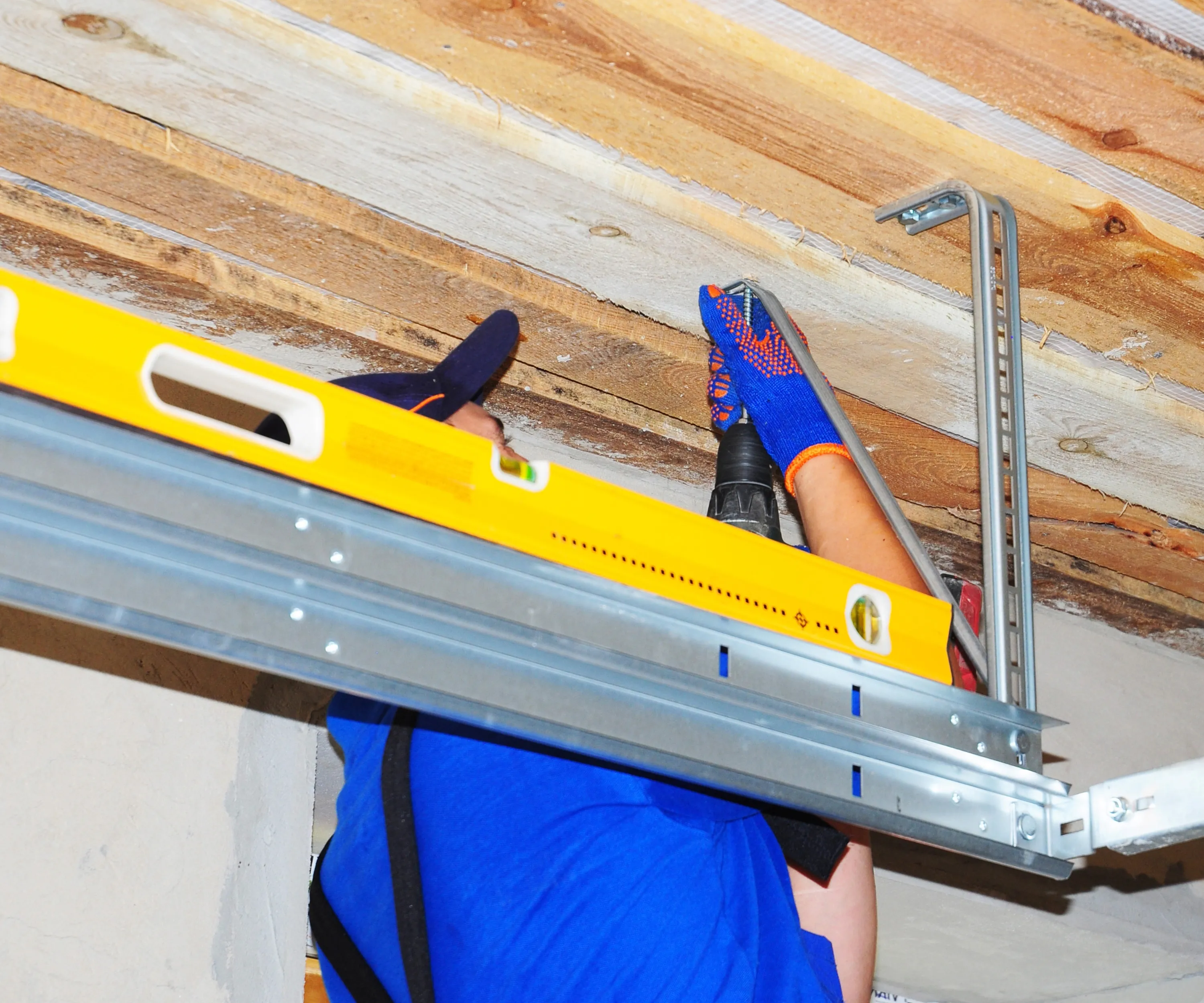 Garage door technician performing maintenance service to avoid emergency garage door repair in Colorado Springs