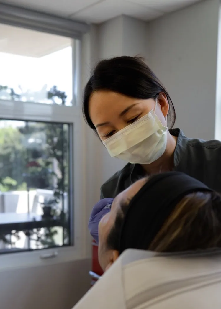 Technician performing a non-surgical wrinkle reduction with Botox for an aesthetic surgery journal