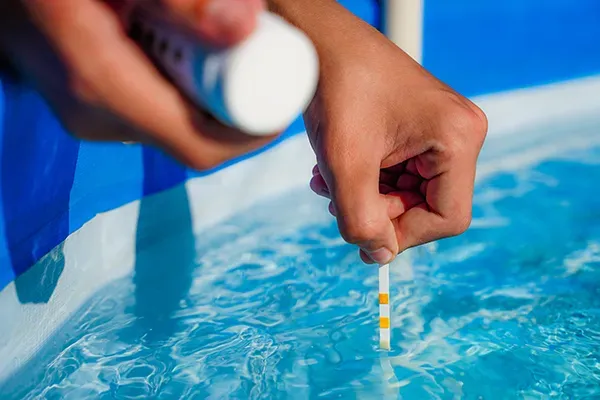 Expert technician testing and balancing pool water in Jupiter, FL, for a pool maintenance service with adequate pool equipment. Jupiter pool cleaners, the best in the pool industry, guarantee customer satisfaction.