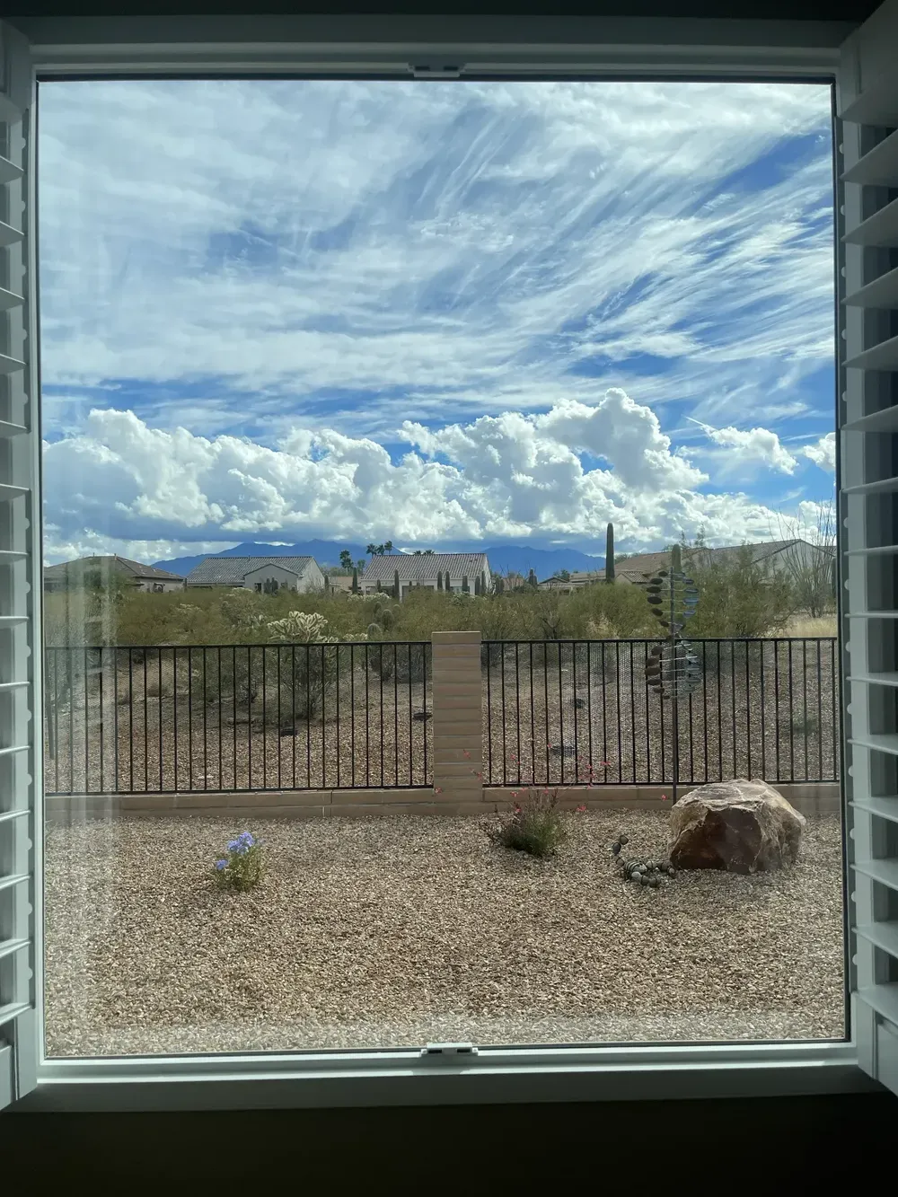 A crystal-clear view through a window cleaned by a window washer using a razor blade and microfiber cloth, showing the best way to achieve a streak free finish without damaging solar panels nearby and giving a full refund.