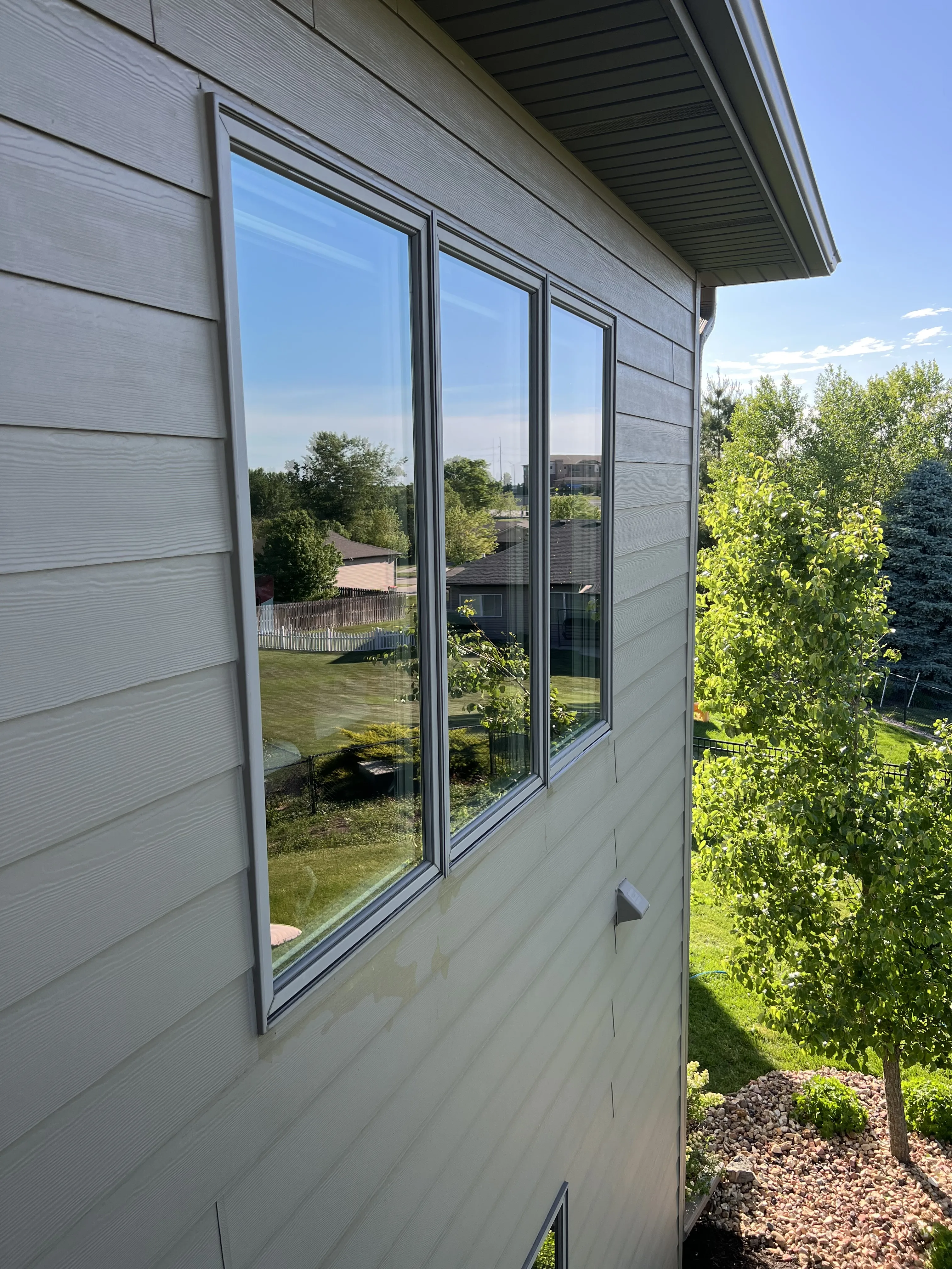 A room with clean windows, bathed in sunlight after Endless Exterior Solutions, Expert cleaning, including window screens and sils.