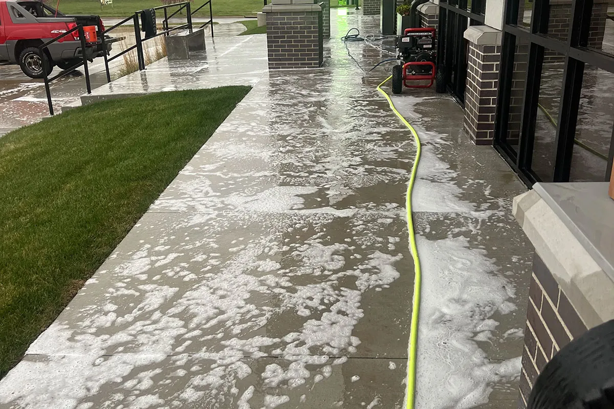 Soapy warm water is being used to wash concrete.