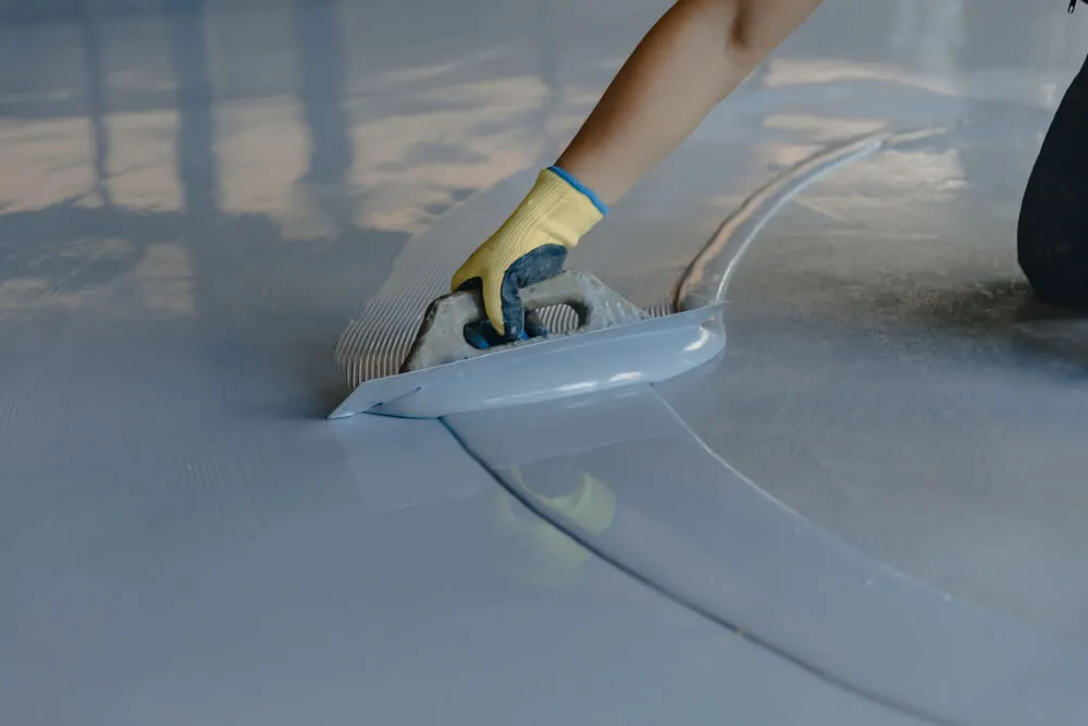 Epoxy flooring being applied in a clean garage space
