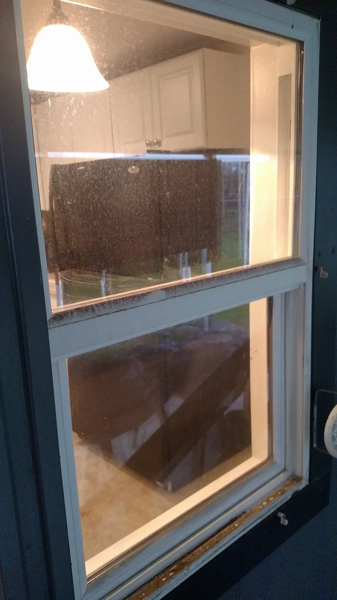 A dusty, grimy window before Two Guys Window Cleaning service in Redding, CA