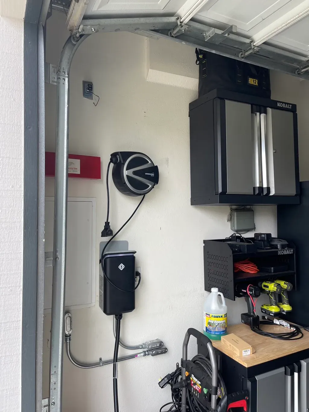 Licensed Electricians performing EV charger installation in a residential San Diego garage with professional tools. We also offer lighting installation.