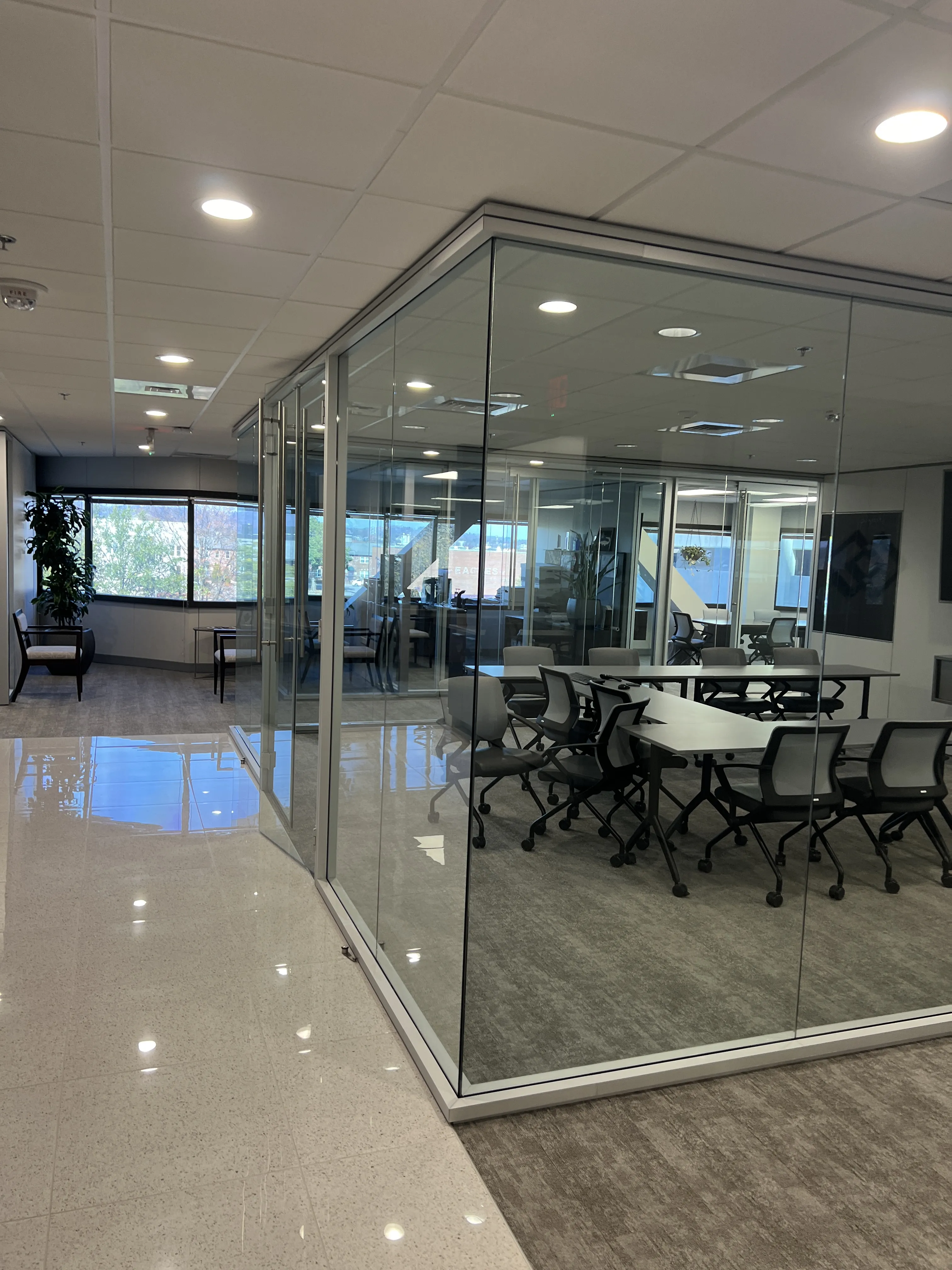 The sparkling clean glass entrance of a modern commercial office building.
