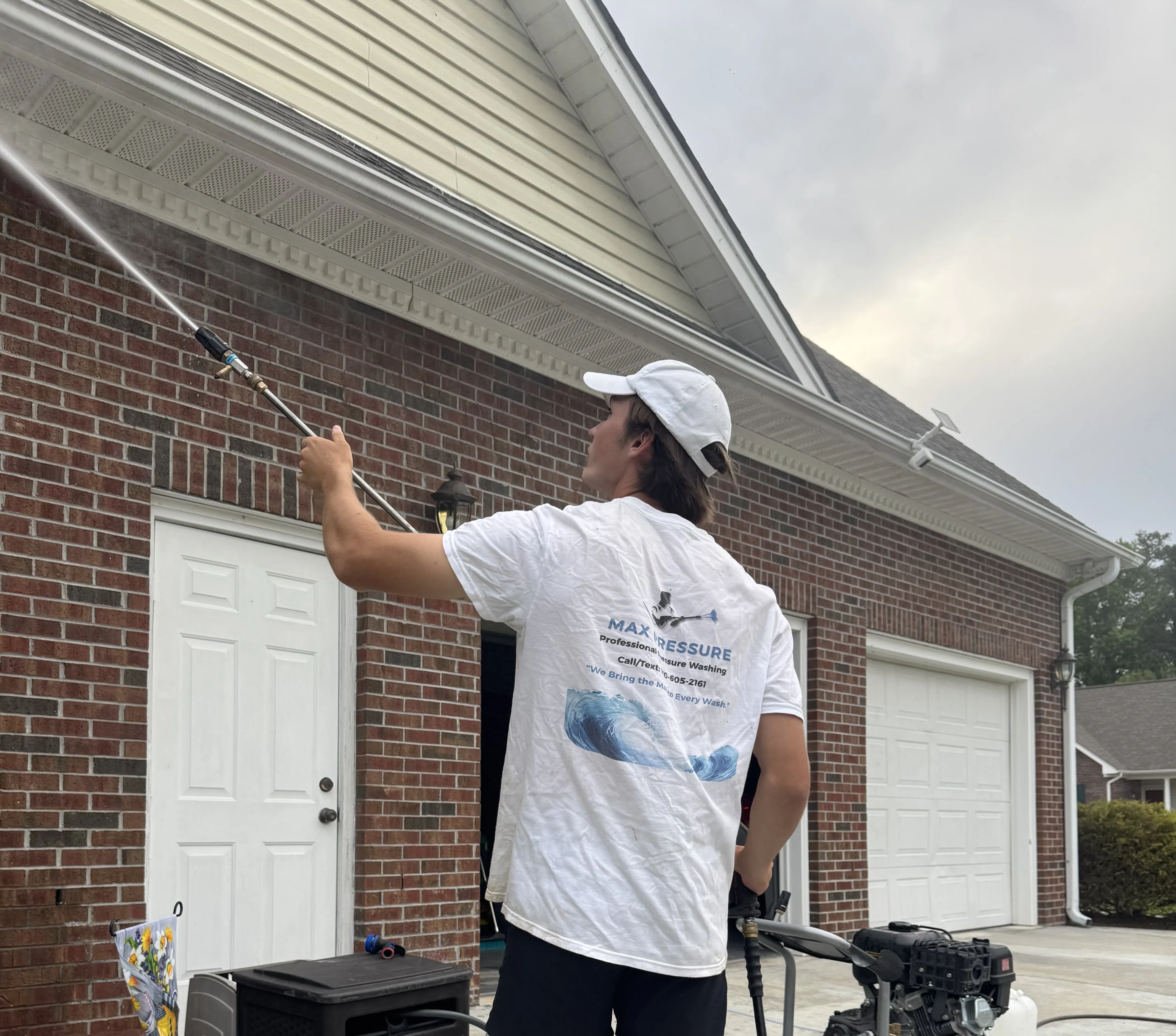 Max Pressure pressure washing technician is providing soft washing for vinyl siding on a Fayetteville home.