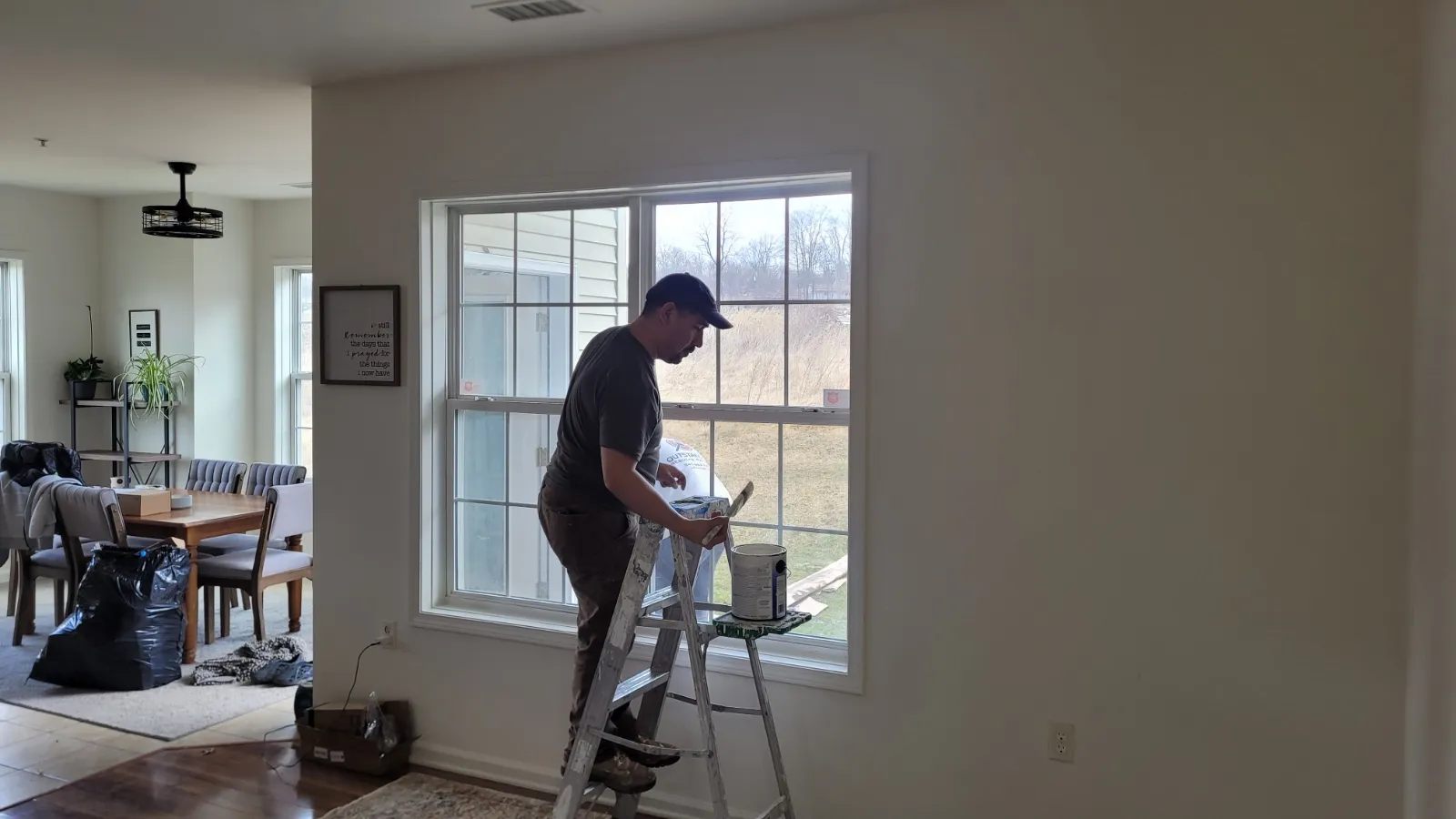 Professional house painters preparing tools for interior painting services with attention to detail and great value.