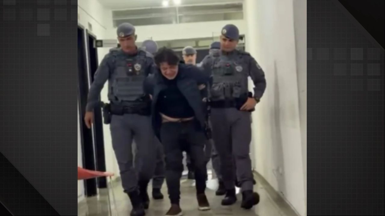 Deputado Marcelo Aguiar, envolvido em confusão com disparo, sendo detido pela Polícia Militar em São Paulo - Foto: Reprodução Homem em prantos, escoltado por policiais militares fardados, dentro de corredor