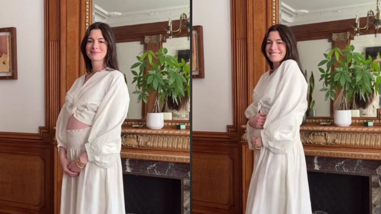 Anne Hathaway exibe a barriga de grávida em vídeo do Instagram ao anunciar a espera do terceiro filho. Anne Hathaway sorrindo, exibindo a barriga de grávida em casa, vestindo branco