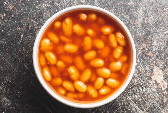 Baked beans in a white bowl.