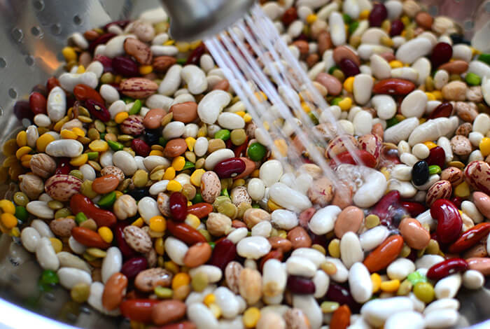 Different types of beans being rinsed.